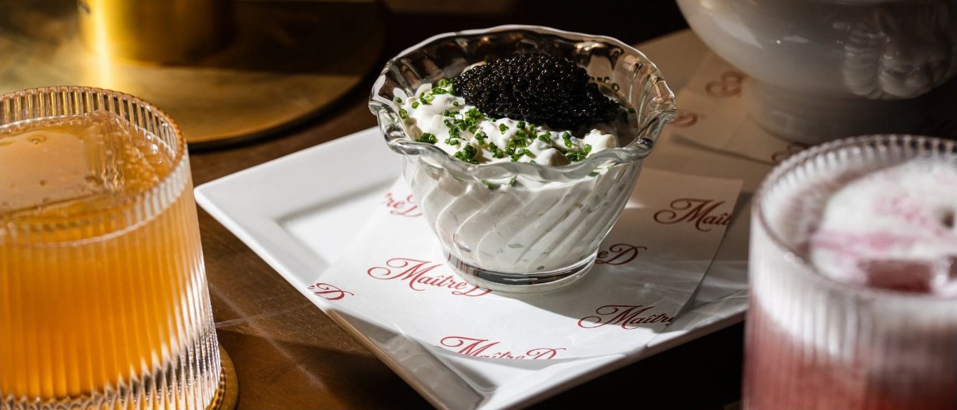 Caviar service and fluted cocktails on Maître D monogrammed napkins