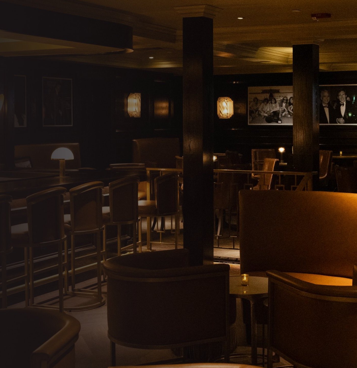 The dimly lit Maître D lounge in Houston with leather chairs and Art Deco sconces